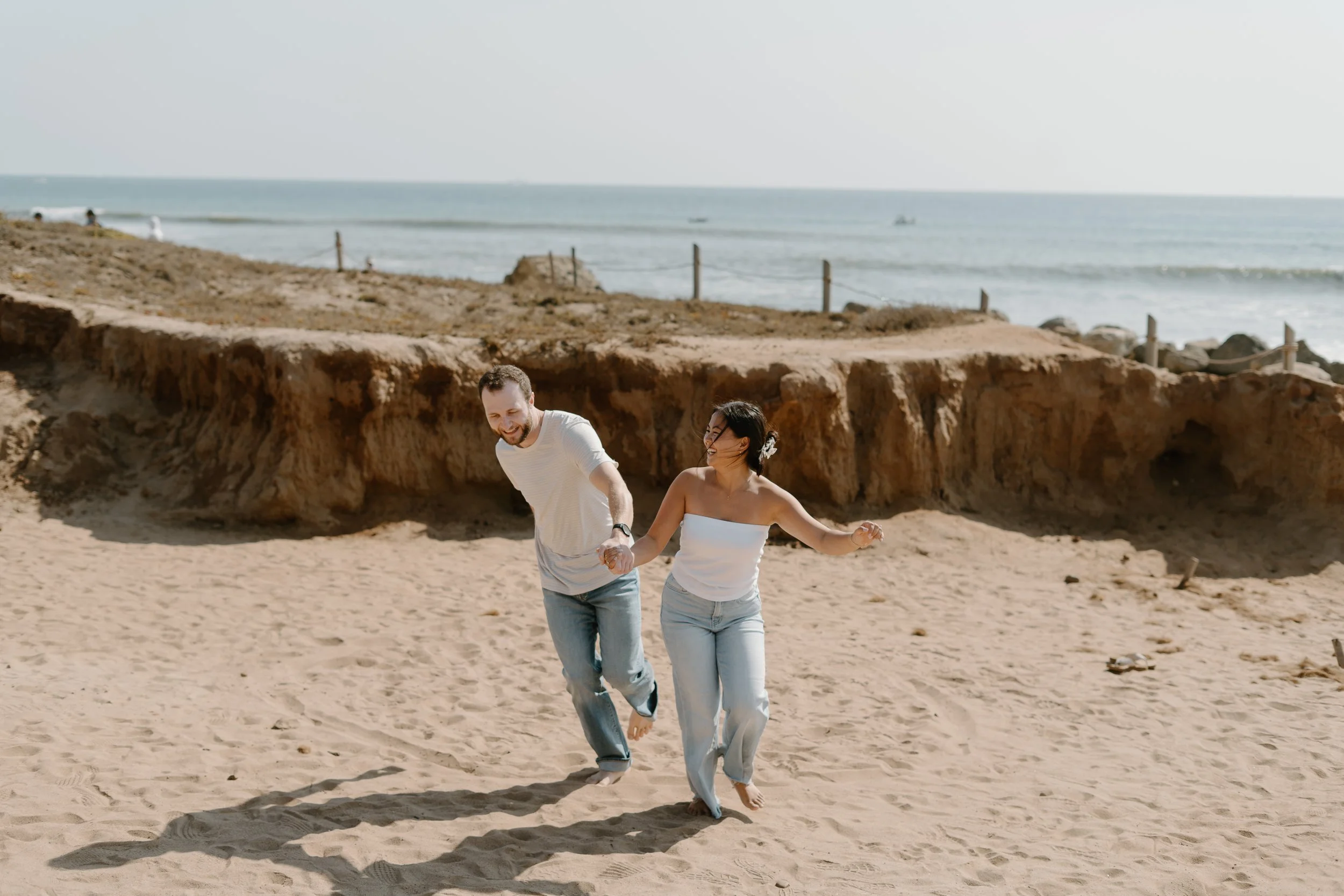 engaged-couple-playing-in-sand.jpg