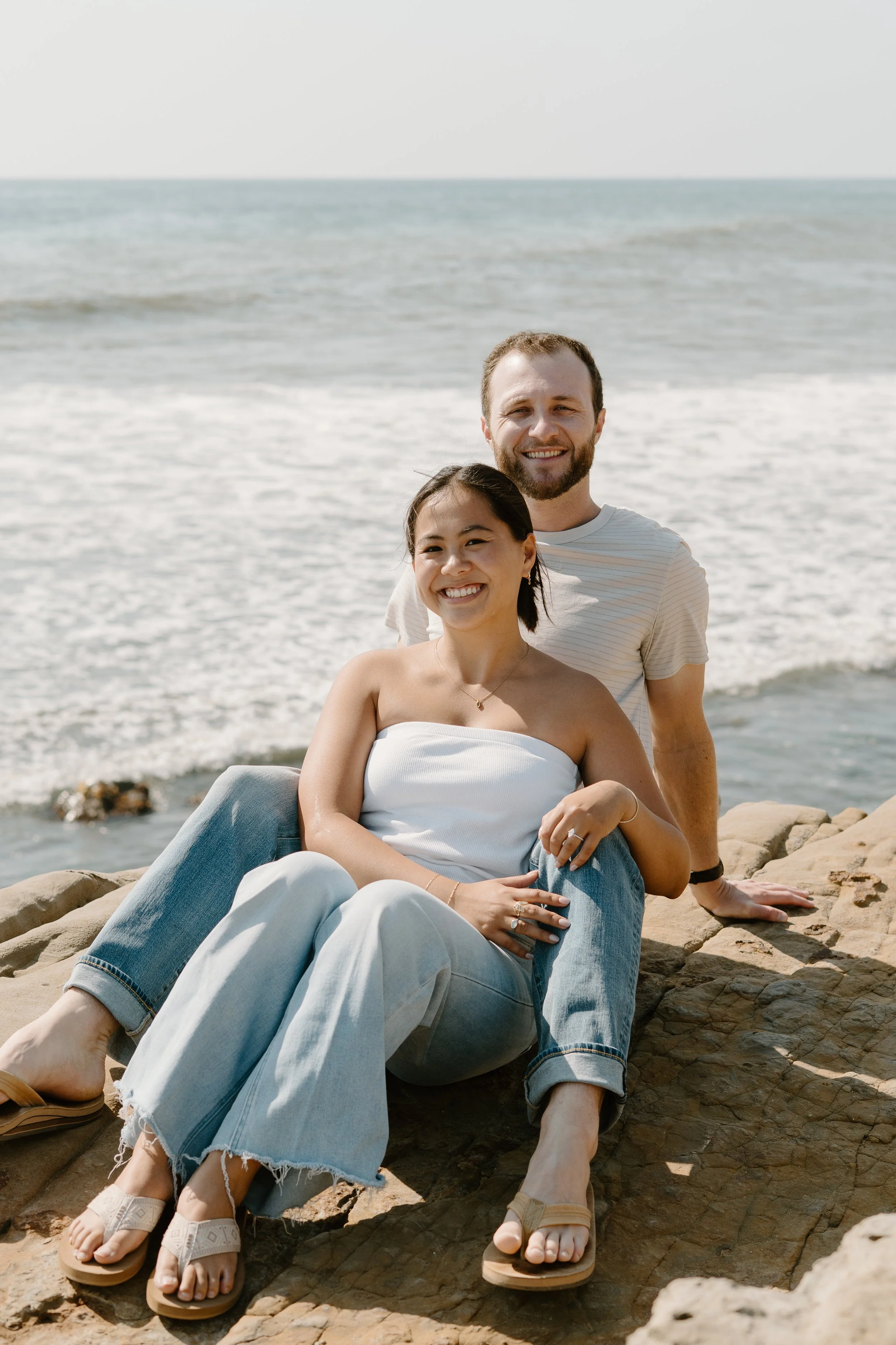 Engaged-couple-sitting-on-cliff-in-point-loma.jpg