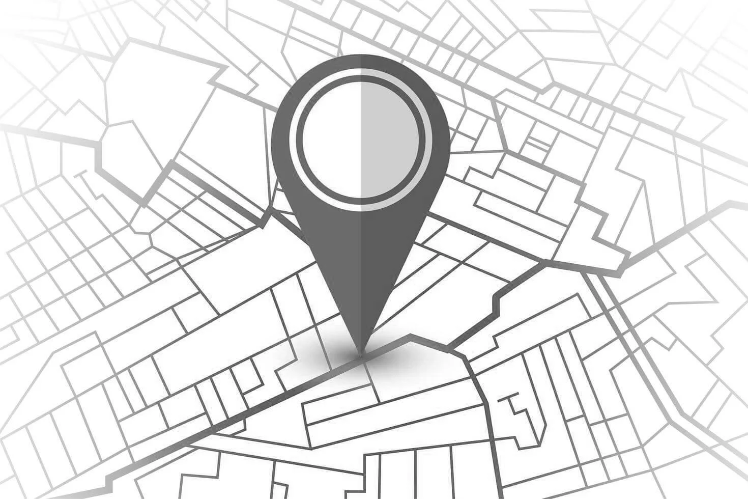 A grayscale digital map with a prominent map pin icon placed on a specific location.
