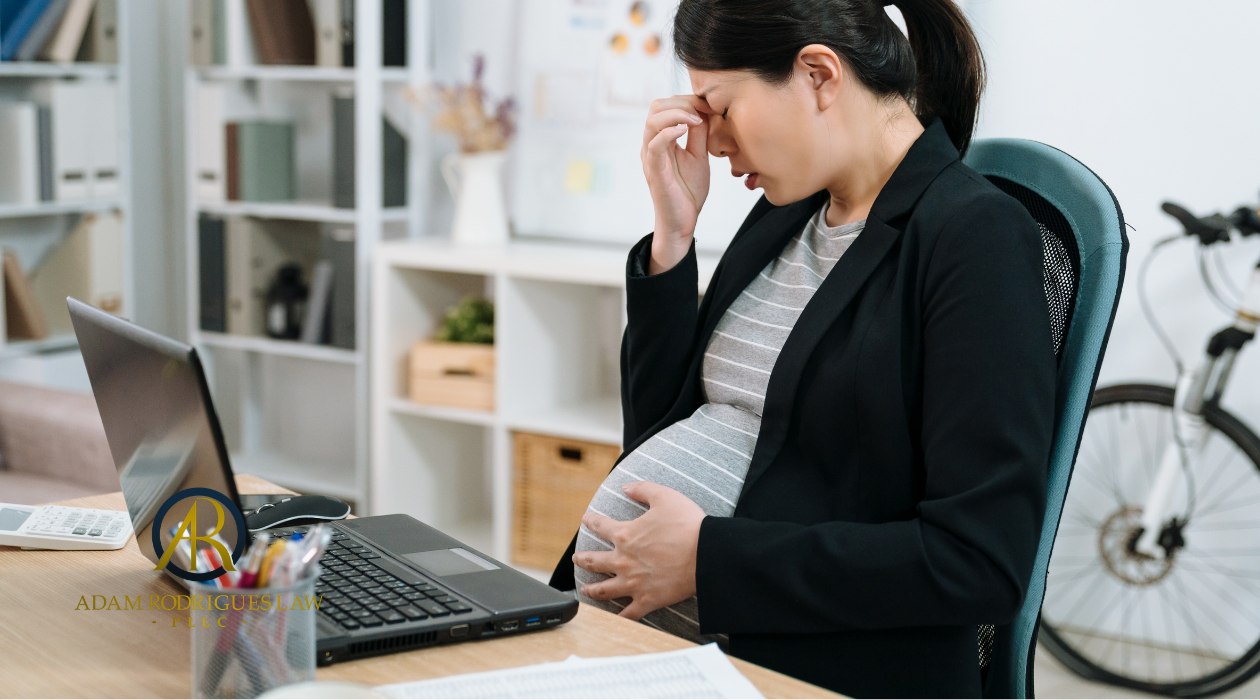 Pregnant-woman-at-desk-fustrated-How-Do-You-Prove-Pregnancy-Discrimination-and-Retaliation-from-employer-Adam-Rodrigues-TN-employment-law.png