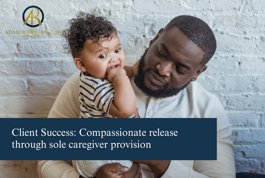Father holding his young child after compassionate release under the sole caregiver provision, 18 U.S.C. § 3582(c)(1)(A), Adam Rodrigues Law attorney at law