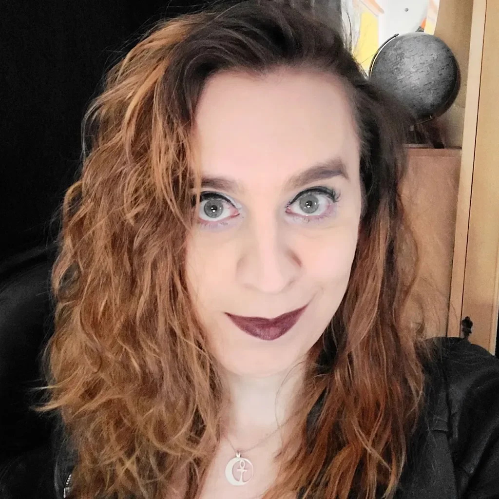 Sophie Edwards gazes into the camera in a dramatic, vampy look.