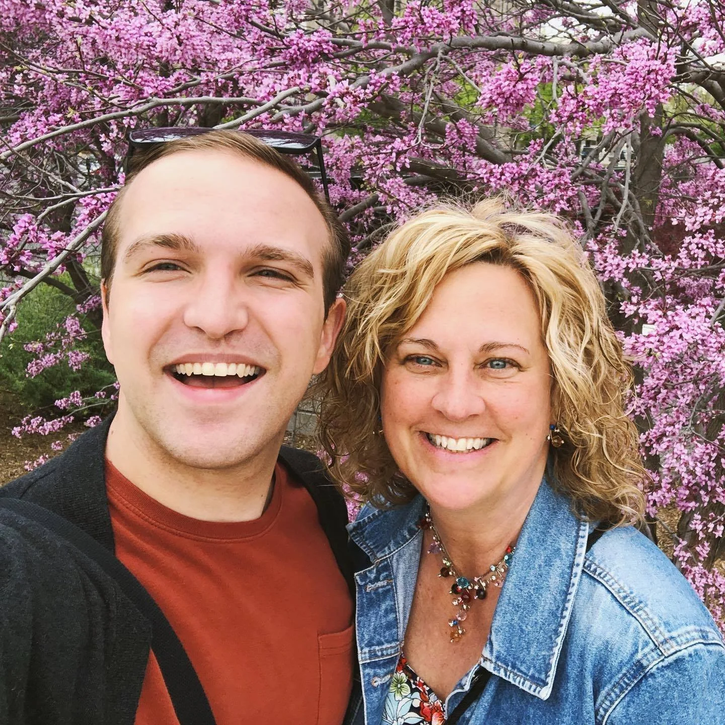 Kari Jo Stefanski and her son Cam Stefanski in front of some gorgeous spring blossoms.
