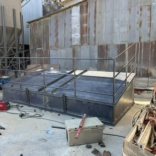 On site fabricated lids for large industrial feed bins with handrail