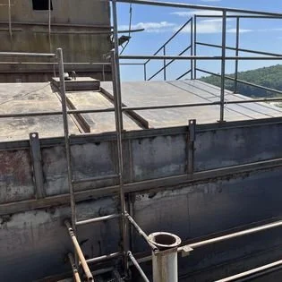 Completed installation of feed bin tops on fabricated new bins. Handrail and access tied into existing structures