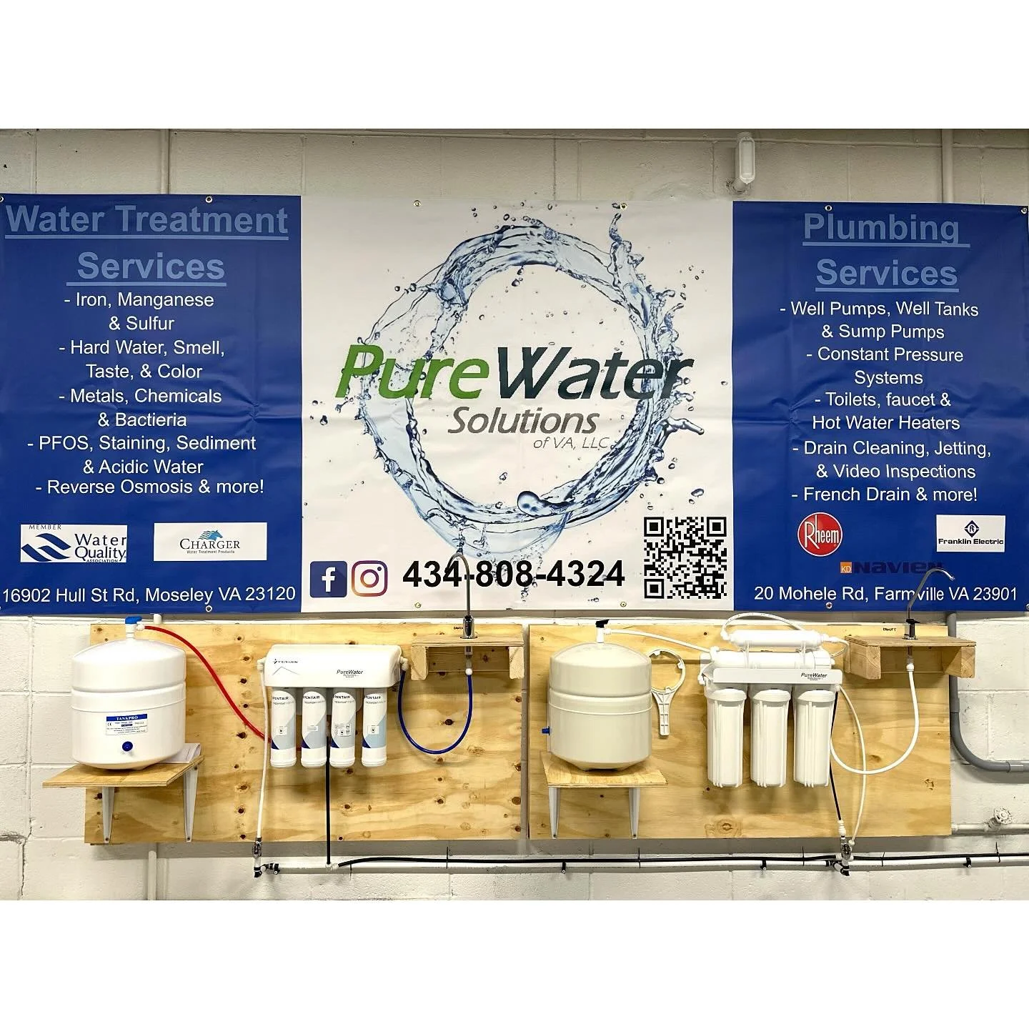 Display of water purification and filtration systems with a sign listing water treatment and plumbing services in Virginia.