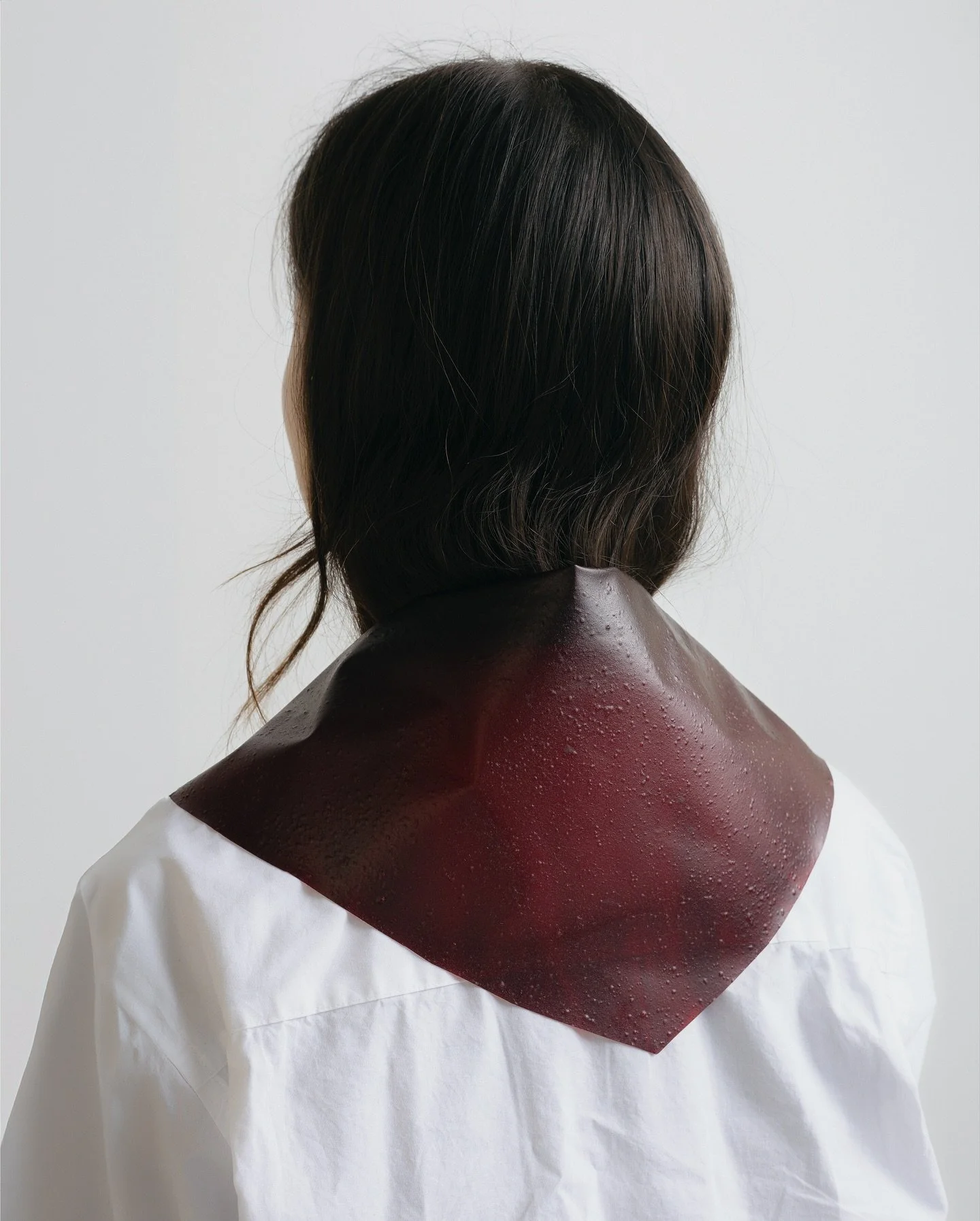Fall issue: Styled wide across the shoulders, the scarf reads as effortless. Cut from fruit leather, it carries the look of the season&rsquo;s supple hides with the unexpected lure of something edible.