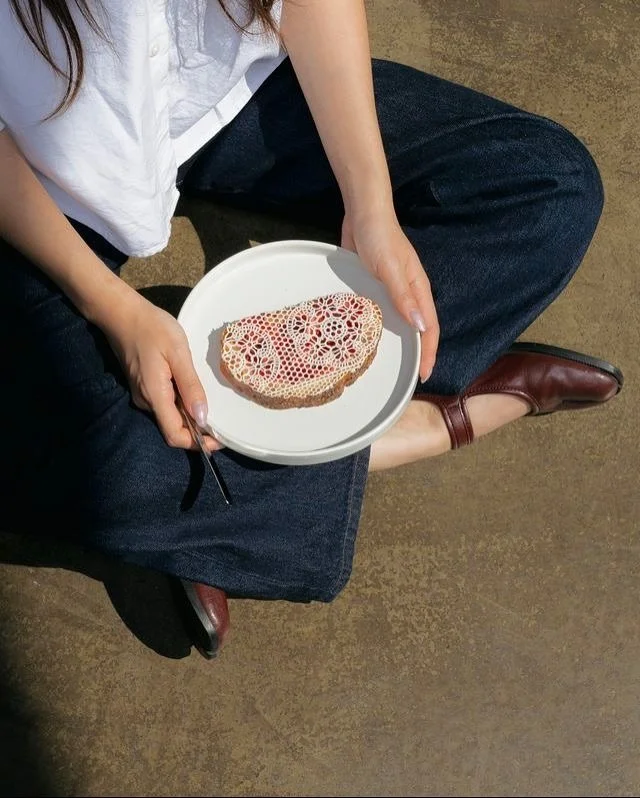 From sheer layers to sculptural knits, designers recast the everyday as ornament. Butter belongs in that same dialogue, here, worked into delicate lace that dissolves across toast and jam, giving breakfast the drama of a runway detail.