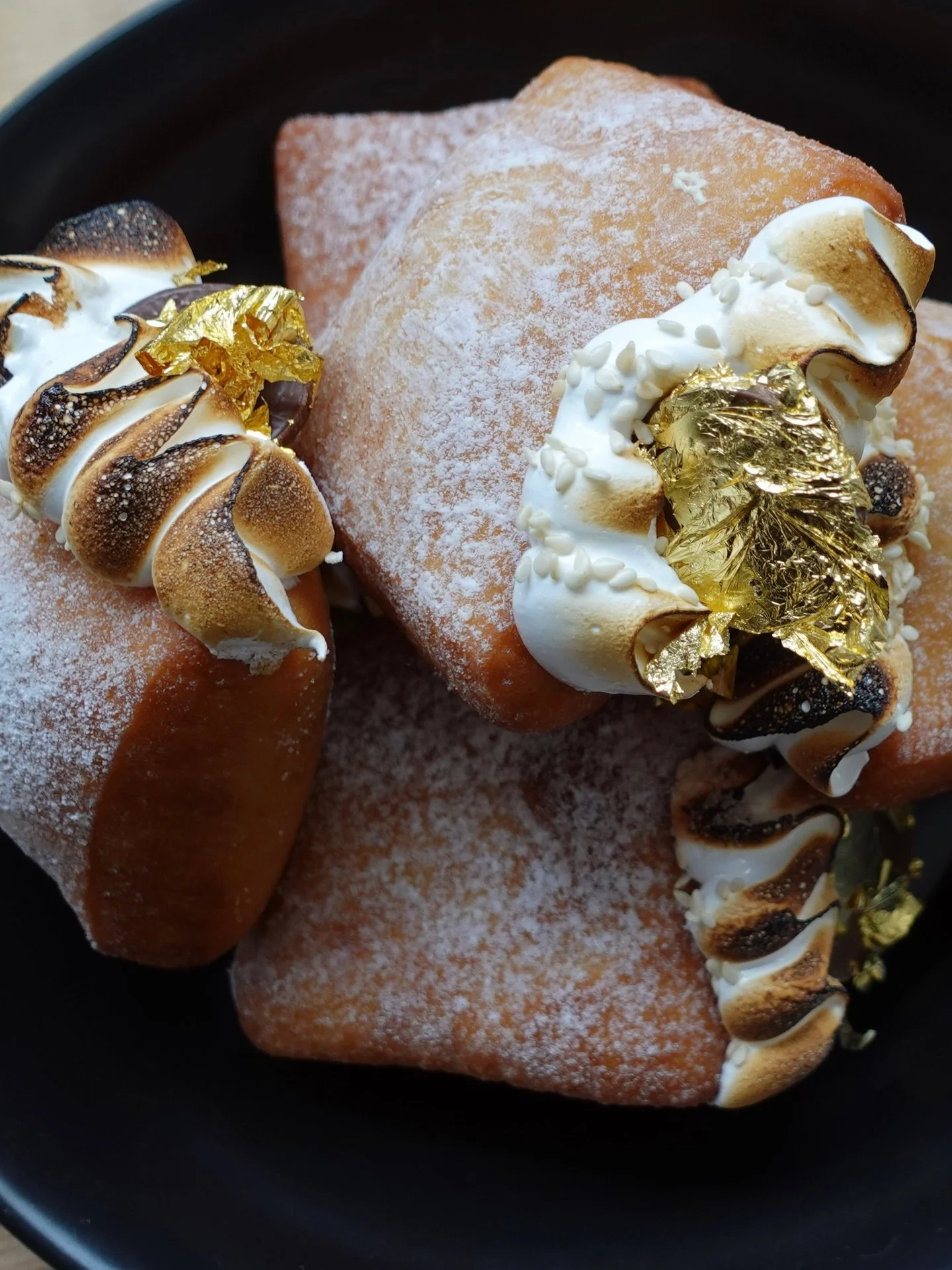 Happy Hanukkah 🤎 We&rsquo;re starting the holiday on a sweet note with chocolate gelt donuts filled with chocolate tahini custard, topped with toasted marshmallow and edible gold foil.