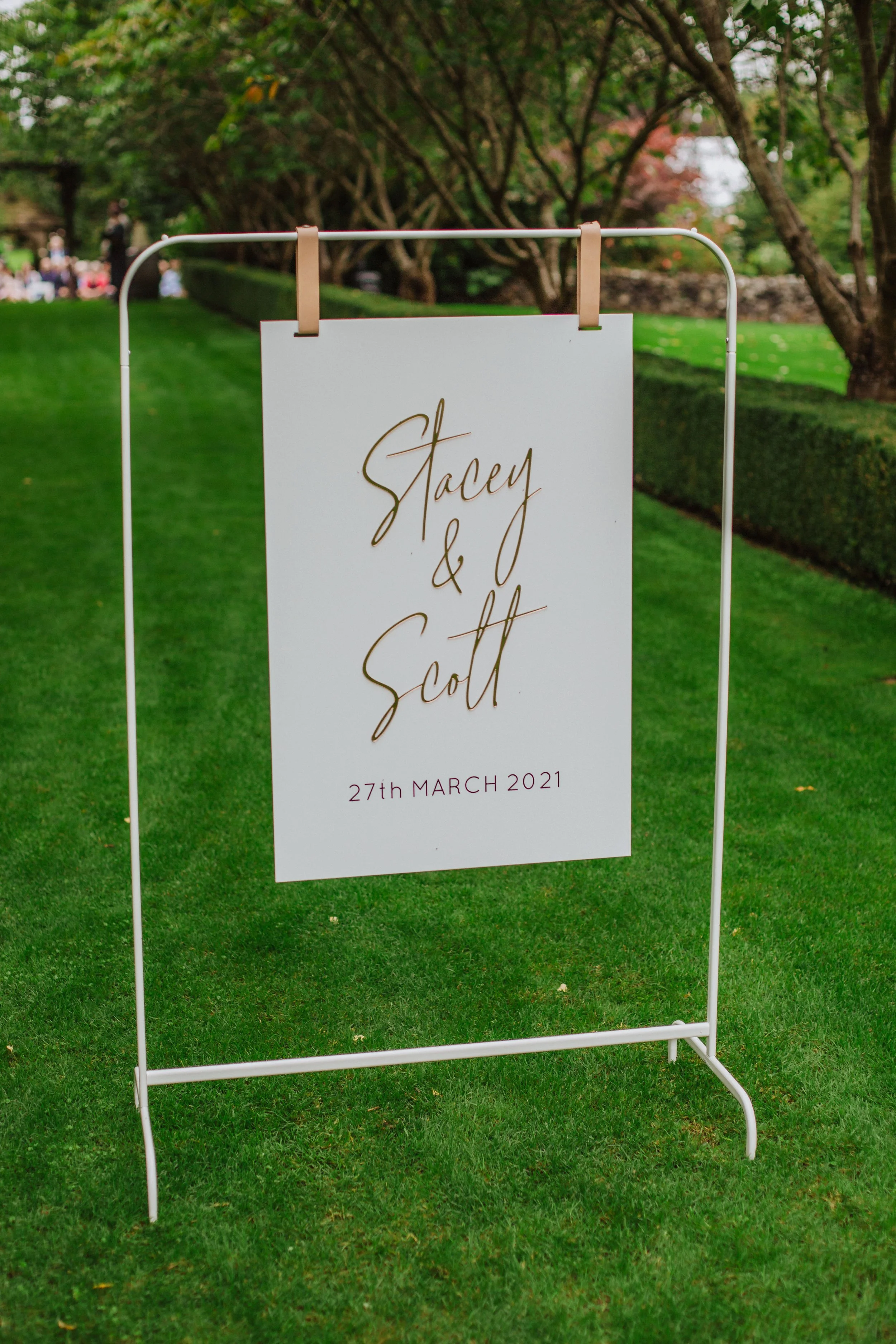 Acrylic signage, signage stand, white signage stand, leather straps, florals, stand, wedding welcome sign