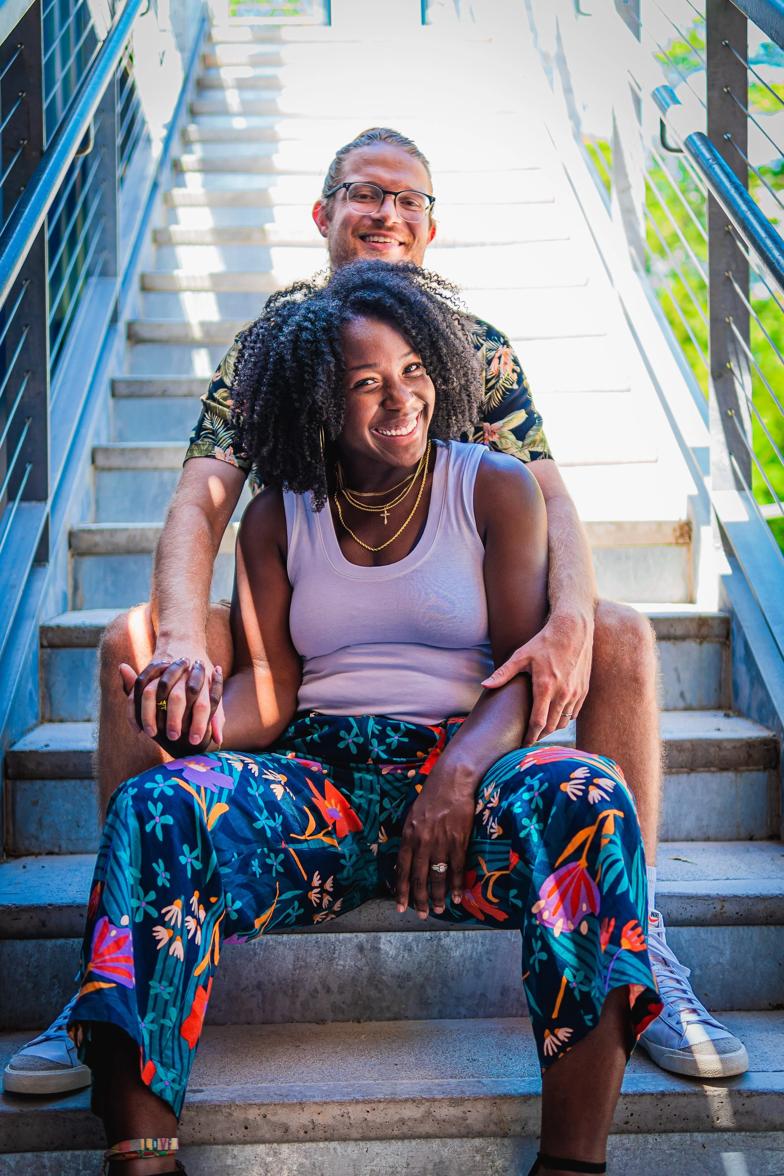 Ashley & Cody pose for a couple's photo on a set of stairs