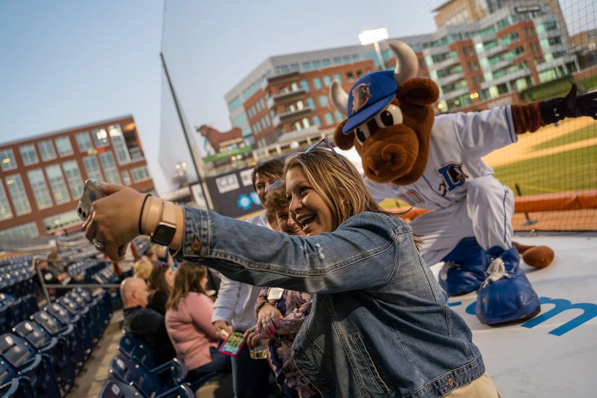 Durham Bulls mascot Wool E. Bull poses for a photo with fans