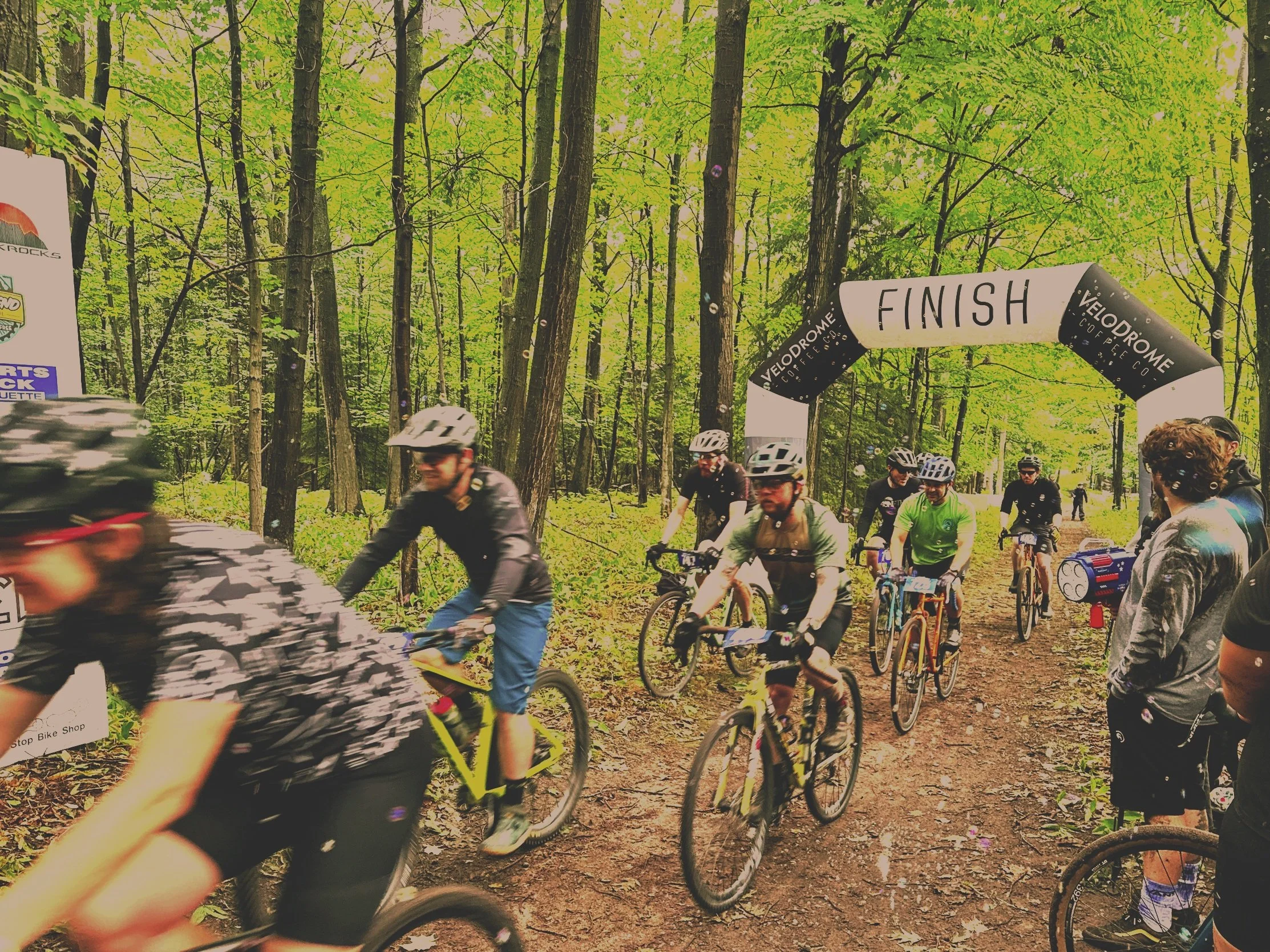 Cyclocross racers on bicycles at a cyclocross race in Marquette, MI