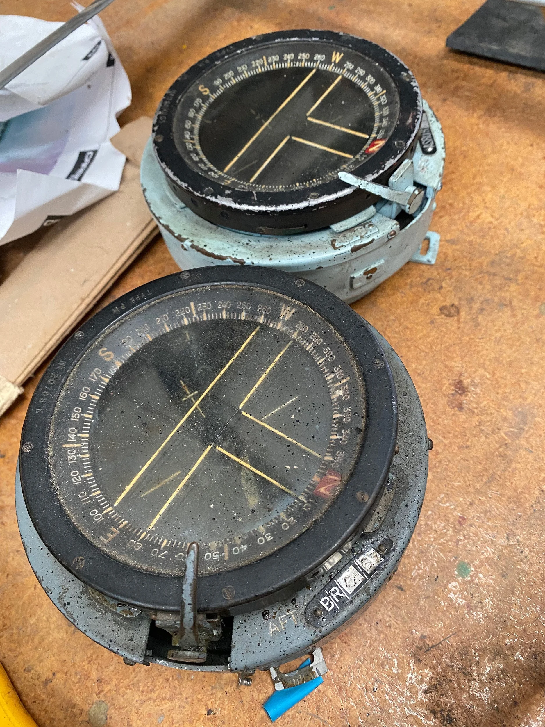 Our two floor mounted compasses before restoration. Very accurate, very cool, but very hard to read down there by your ankles.