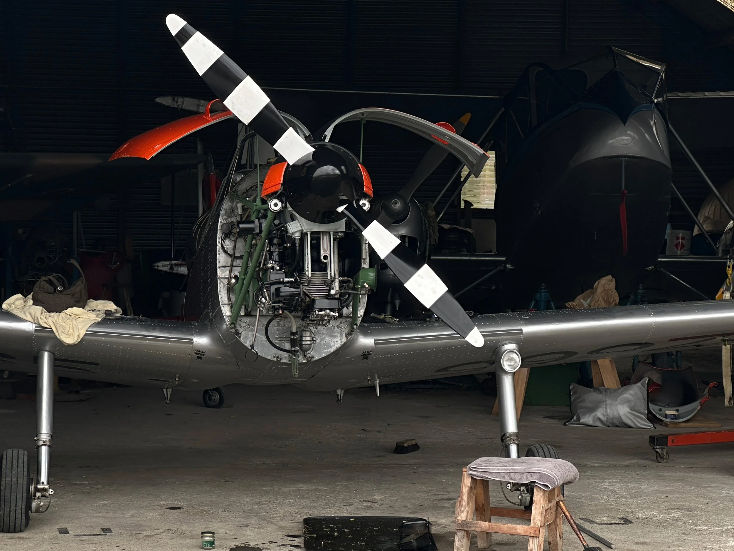 A moody shot in the hangar with lower cowlings removed for engine access.