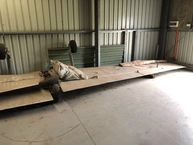 Wings in storage, Australia. Those undercarriage legs would need removal for metal-testing and replacement of the rubber suspension blocks.