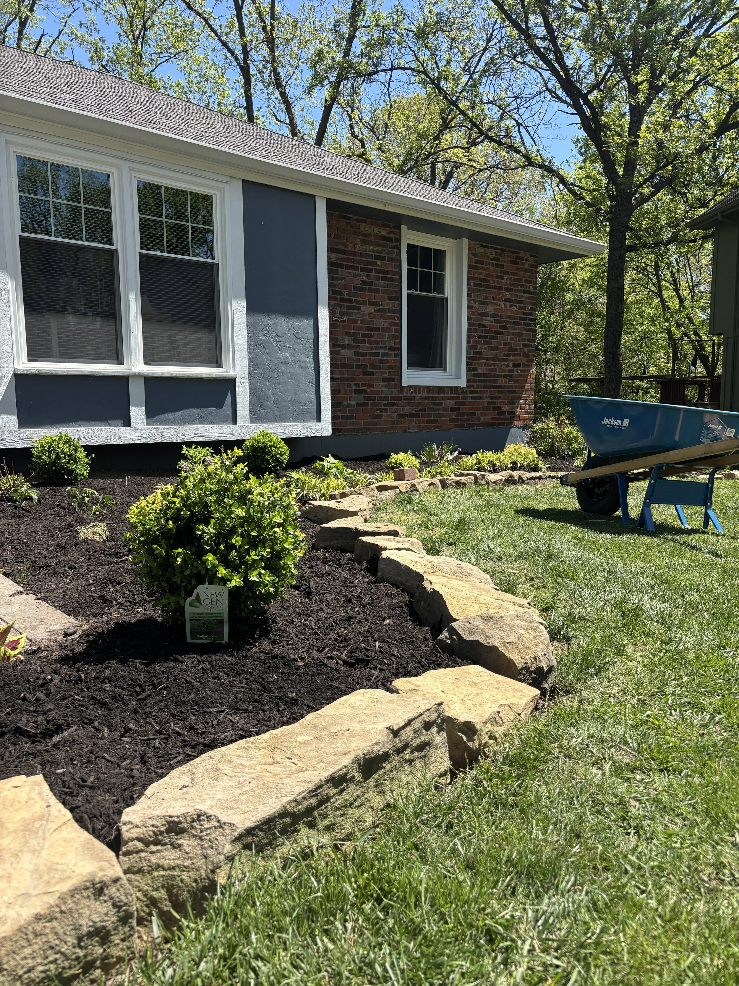 Installation of a beautiful new garden bed with fresh mulch and plants