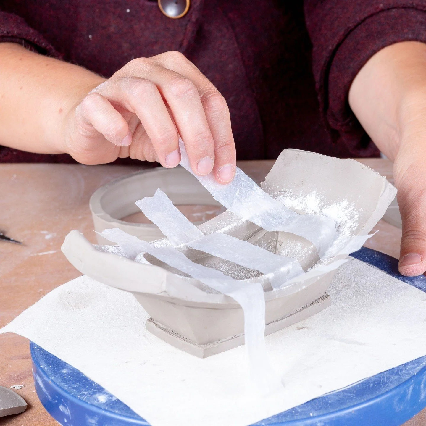 Most potters are well aware of plastic's usefulness in moisture management, but here's another use: lay strips of plastic across the flange or gallery of your piece to help you lift a delicate lid during (or after) its construction.⁠
⁠
This tip is on