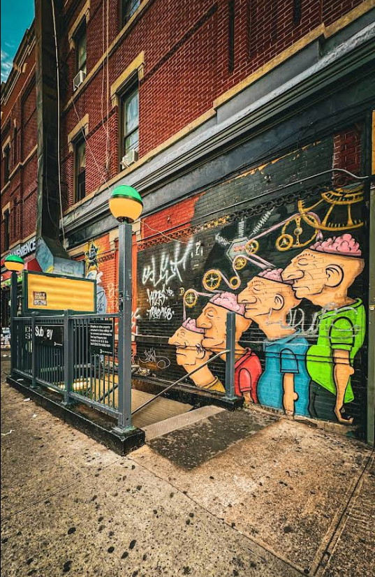 Colorful cartoon graffiti mural on building wall in Bushwick Brooklyn with clock design.