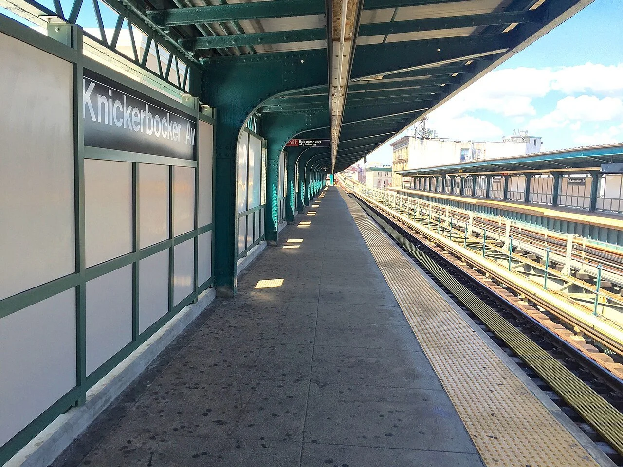 Knickerbocker Avenue subway platform in Bushwick Brooklyn with tracks and canopy.