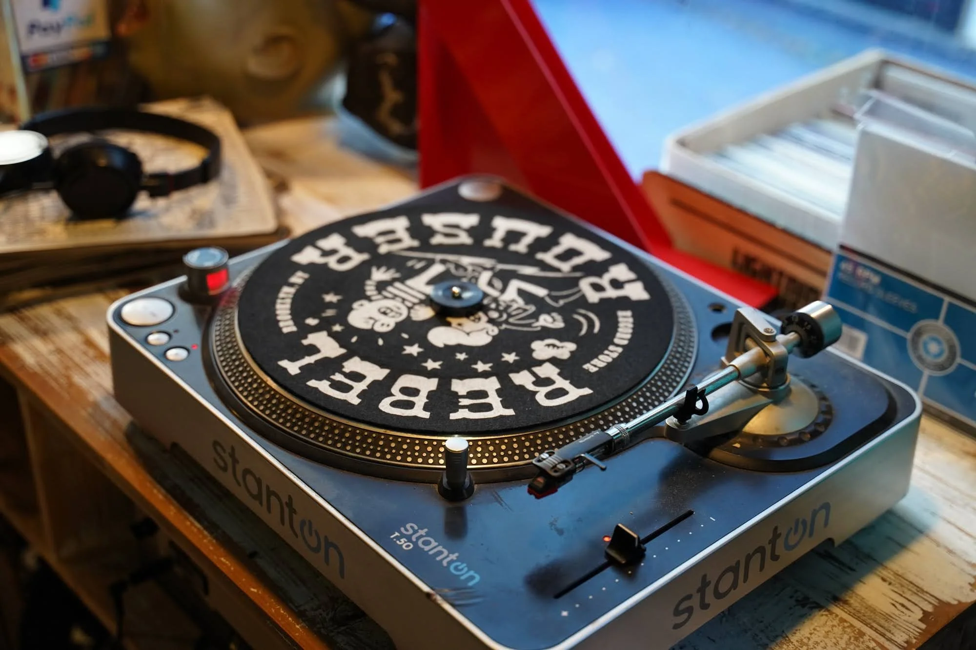 Vintage turntable with black and white vinyl record playing on wooden table in Brooklyn.