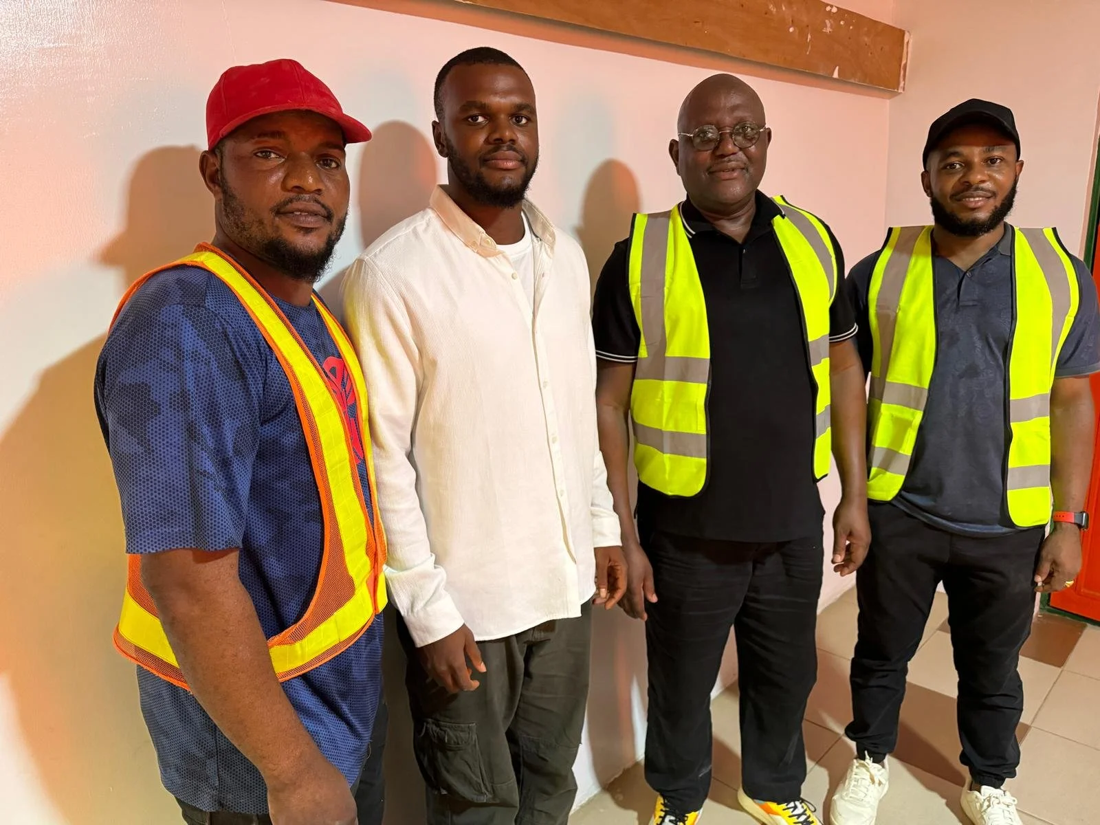 Cassava entrepreneur Dr. Tony Bello collaborating with youth farmers in an agricultural processing center