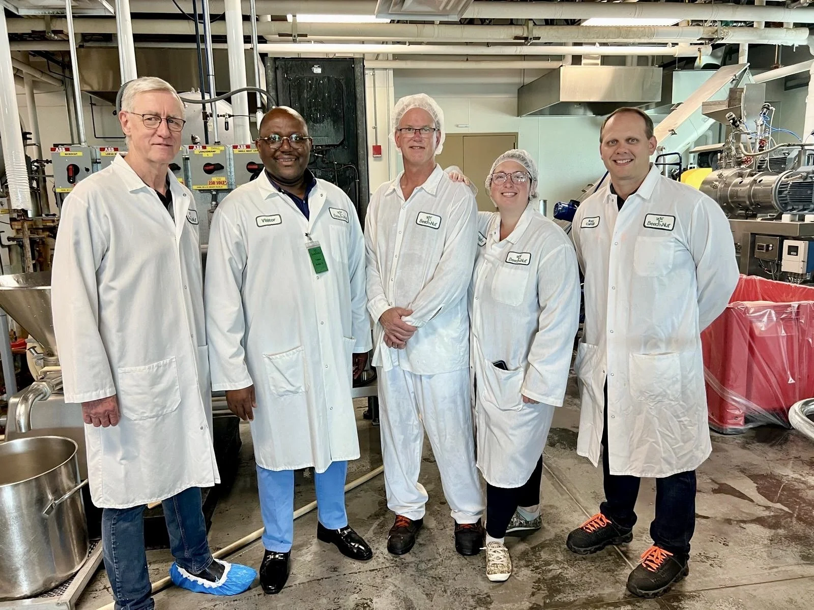 Food science expert Dr. Tony Bello posing with fellow food scientists in a research laboratory