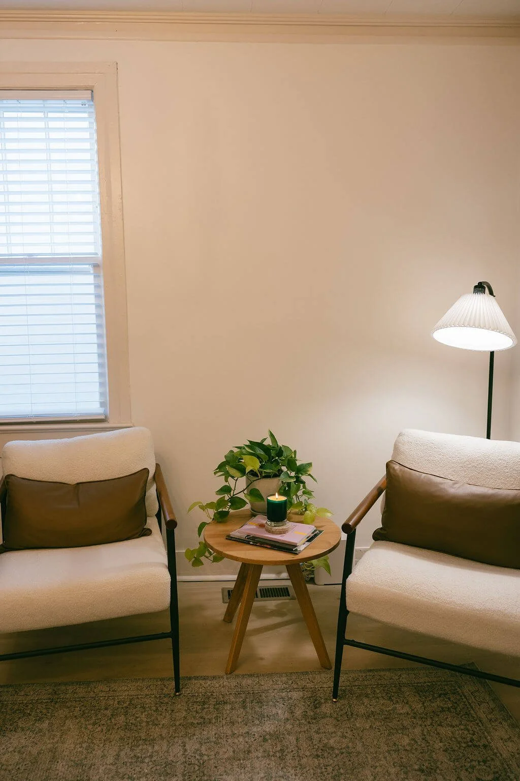 Opulent Properties Office | Two sitting chairs with a lamp, table, candle, plant