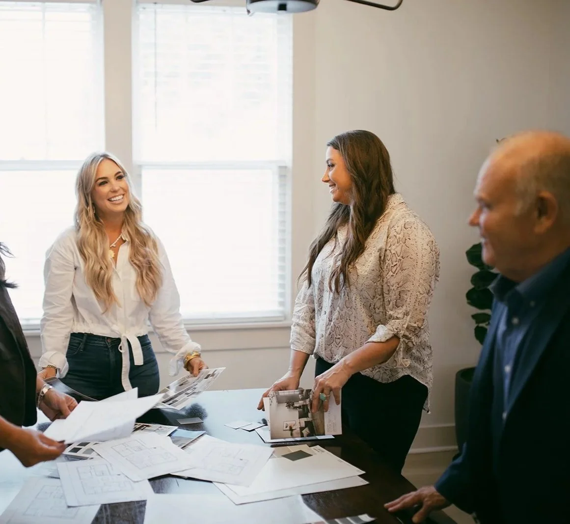 The team at Opulent Property gathered around the conference table in a meeting