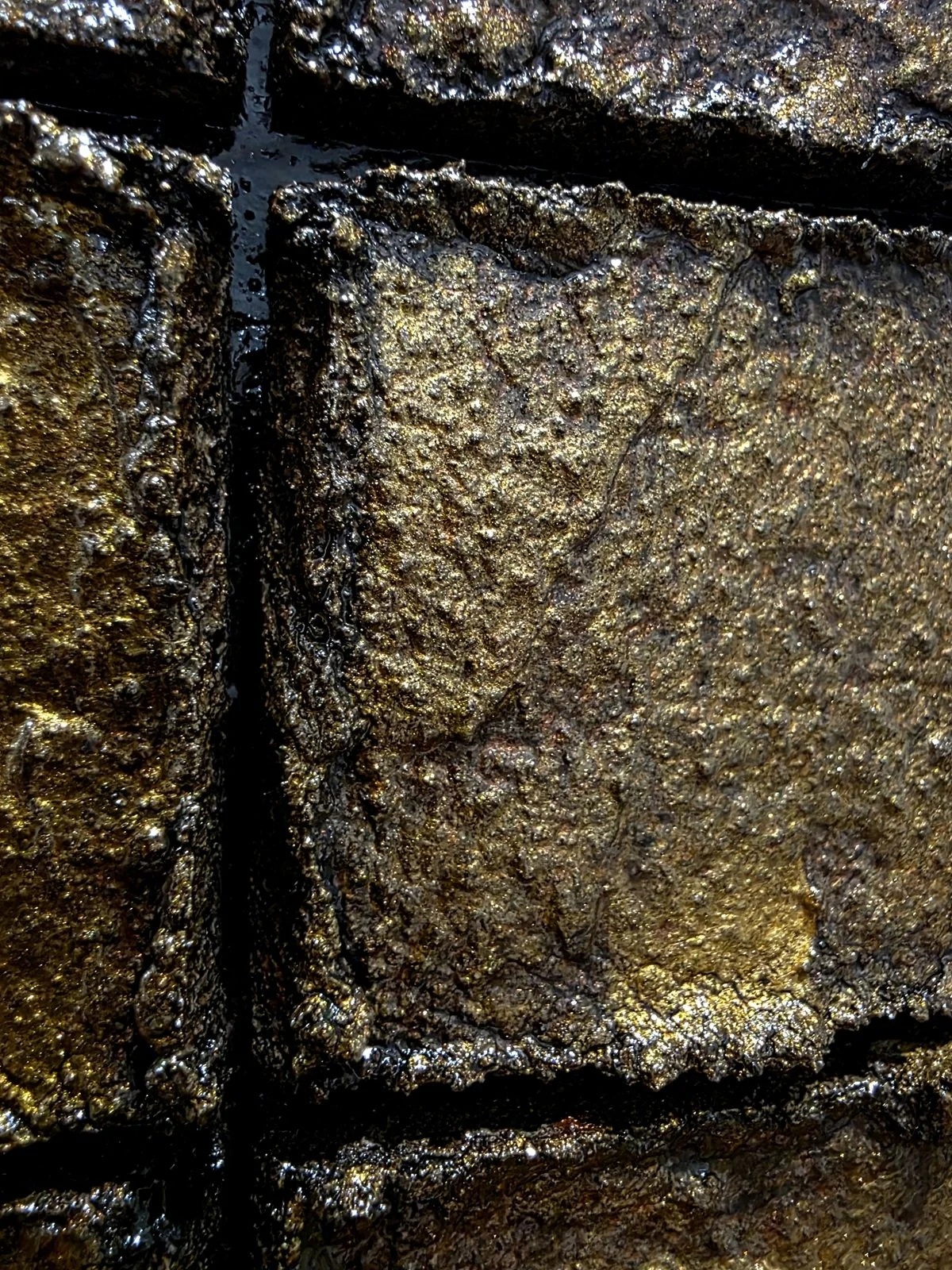 Close‑up of the cube texture on Obelisk VI : After – detailed view of gold‑brown, molten‑like squares.