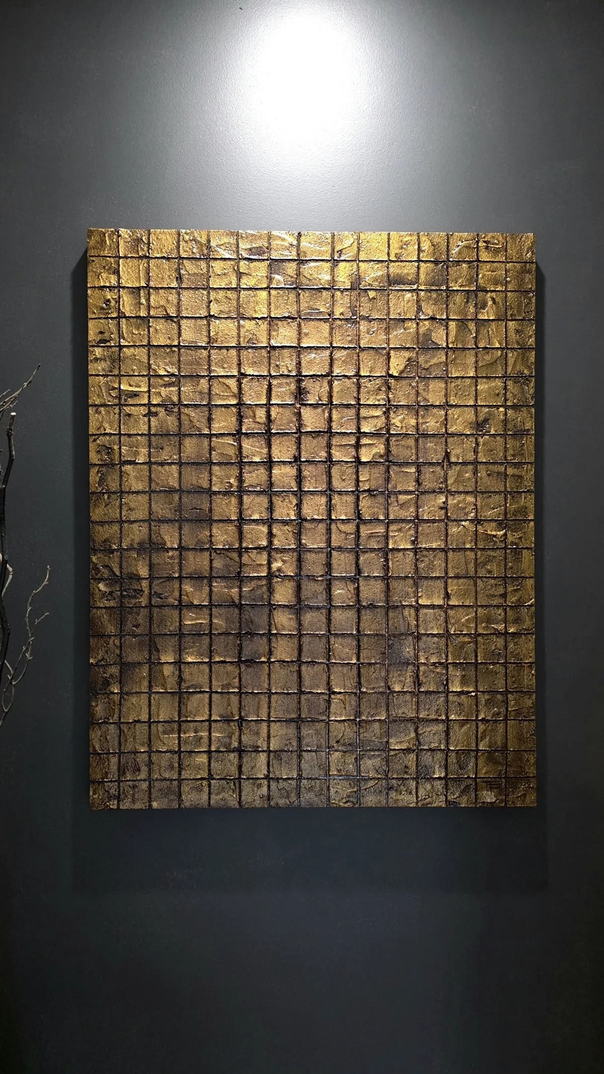 Hero shot of Obelisk VI : After on a dark wall – textured cement surface with luminous gold‑brown cubes in a grid.