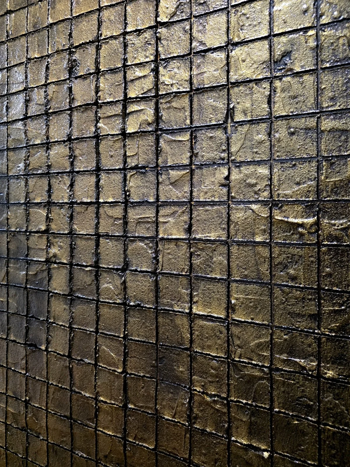 Slightly zoomed view of the grid surface on Obelisk VI : After, showing dark base and shimmering gold‑brown cubes.