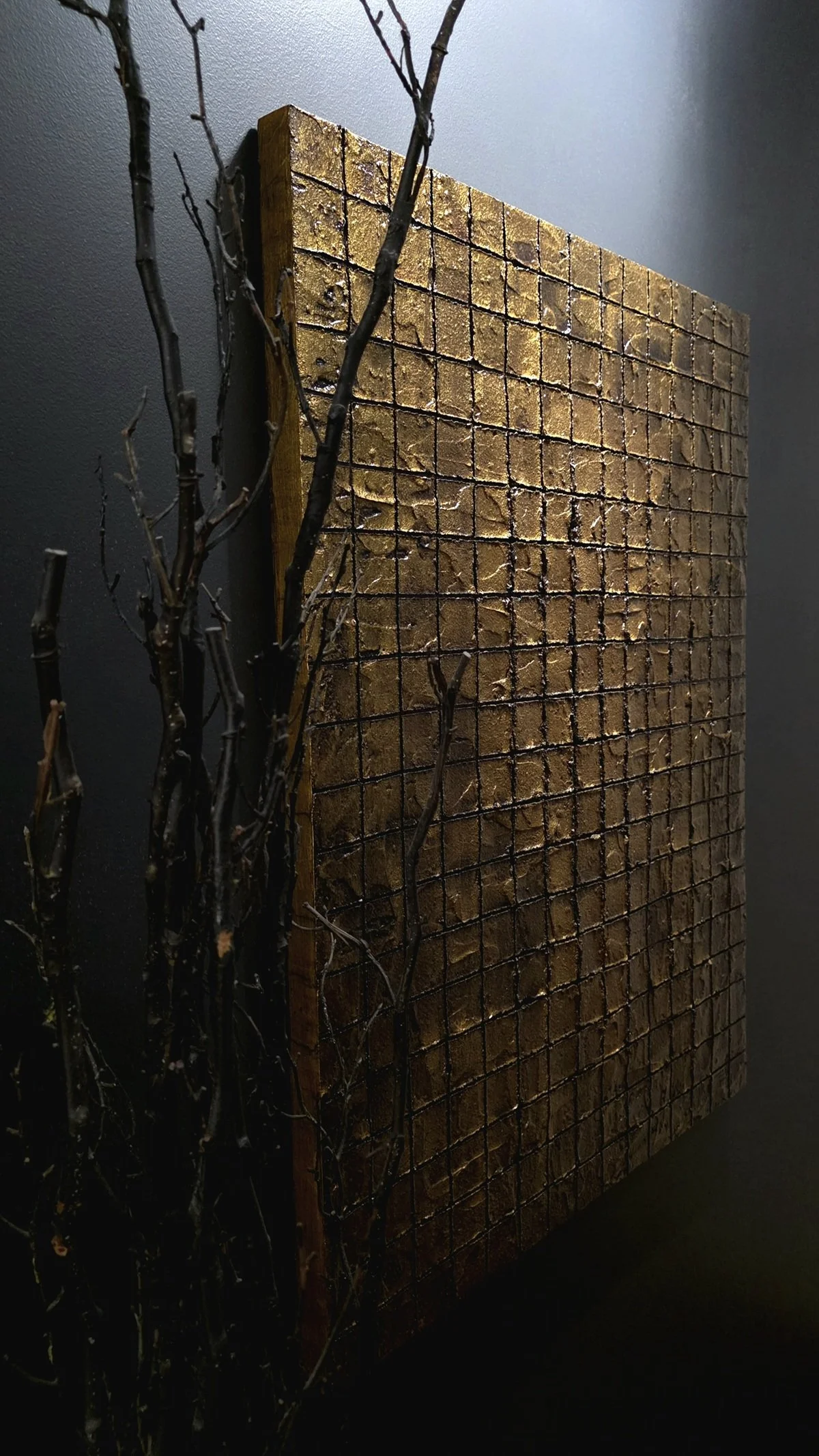 3/4‑angle shot of Obelisk VI : After mounted on a dark wall, showcasing depth and grid pattern.