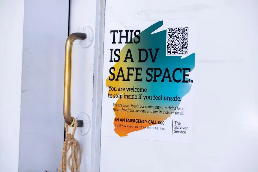The DV Safe Space sticker on a door