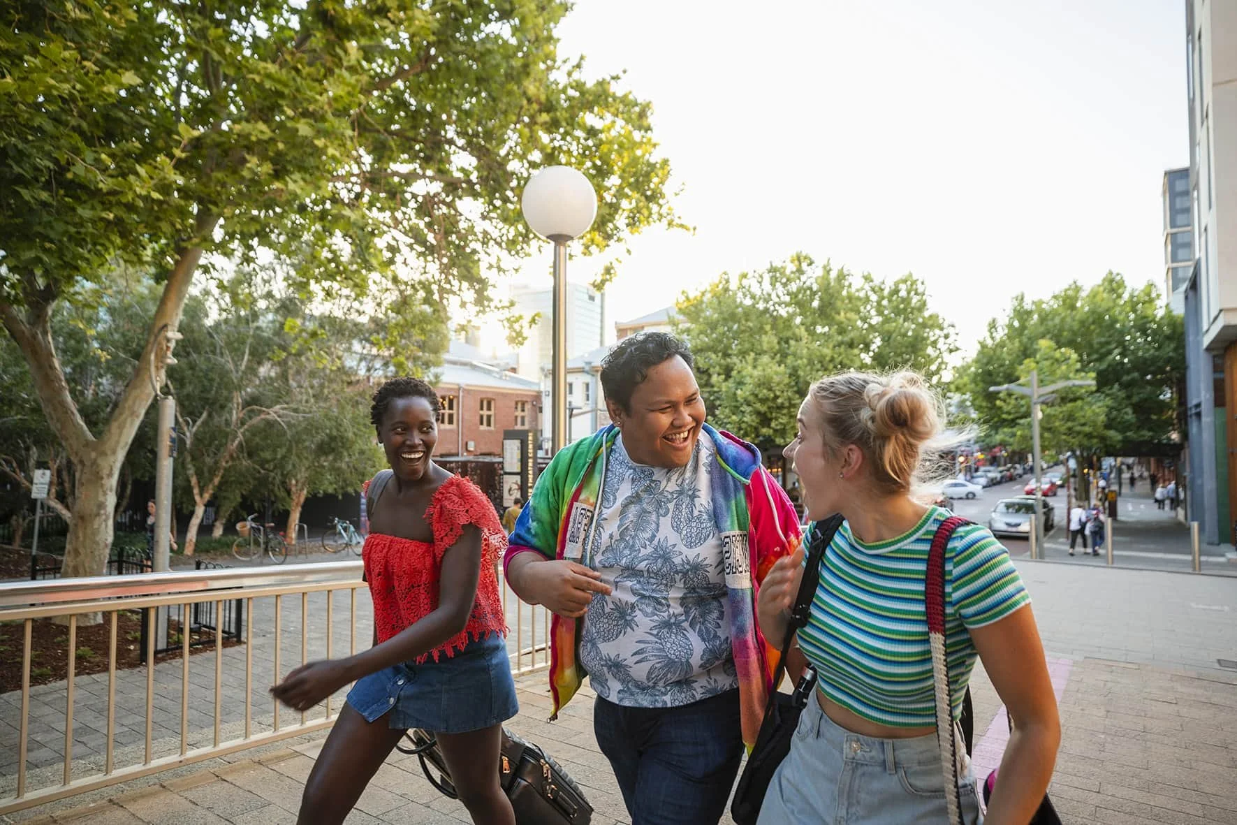 three young people talking and walking