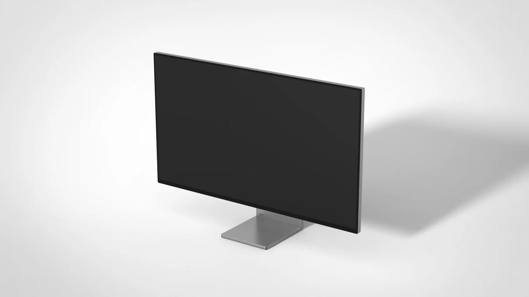 A modern computer monitor with a black screen and a silver stand on a plain gray background.