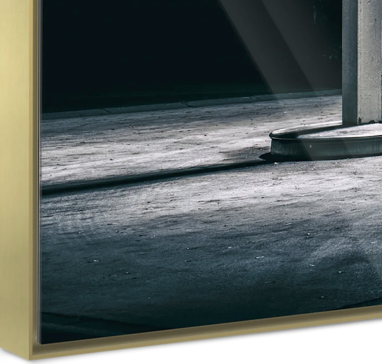 Close-up of a garage door with a yellow frame, showing the ground just outside the opening, with a black rubber bumper on the ground.