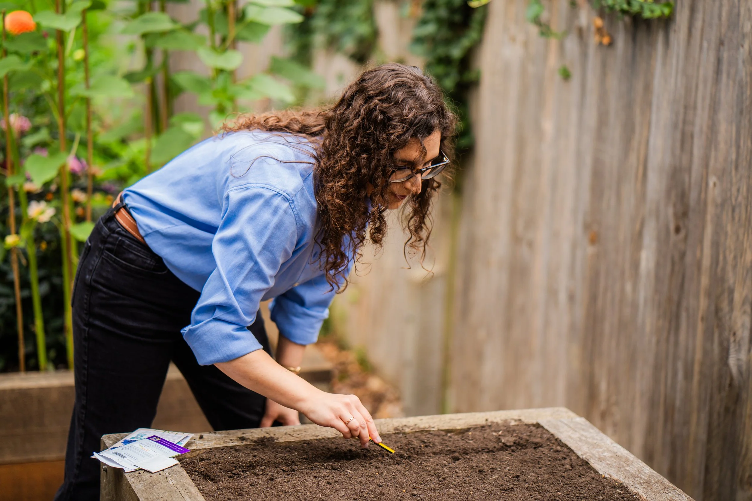 Lisa Unwin sowing seeds in raised garden bed