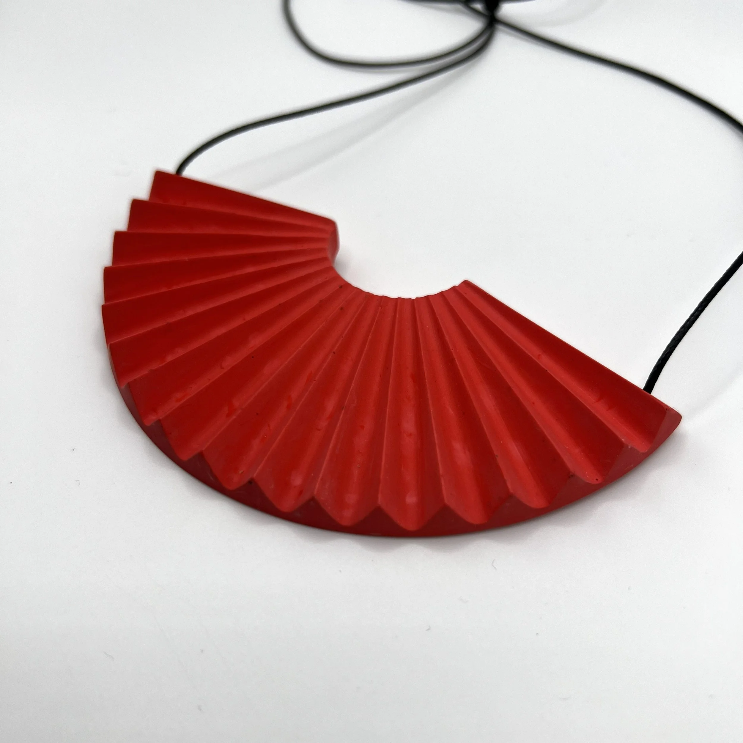 red jesmonite fan shaped statement necklace with adjustable black cord designed by studio mariscat