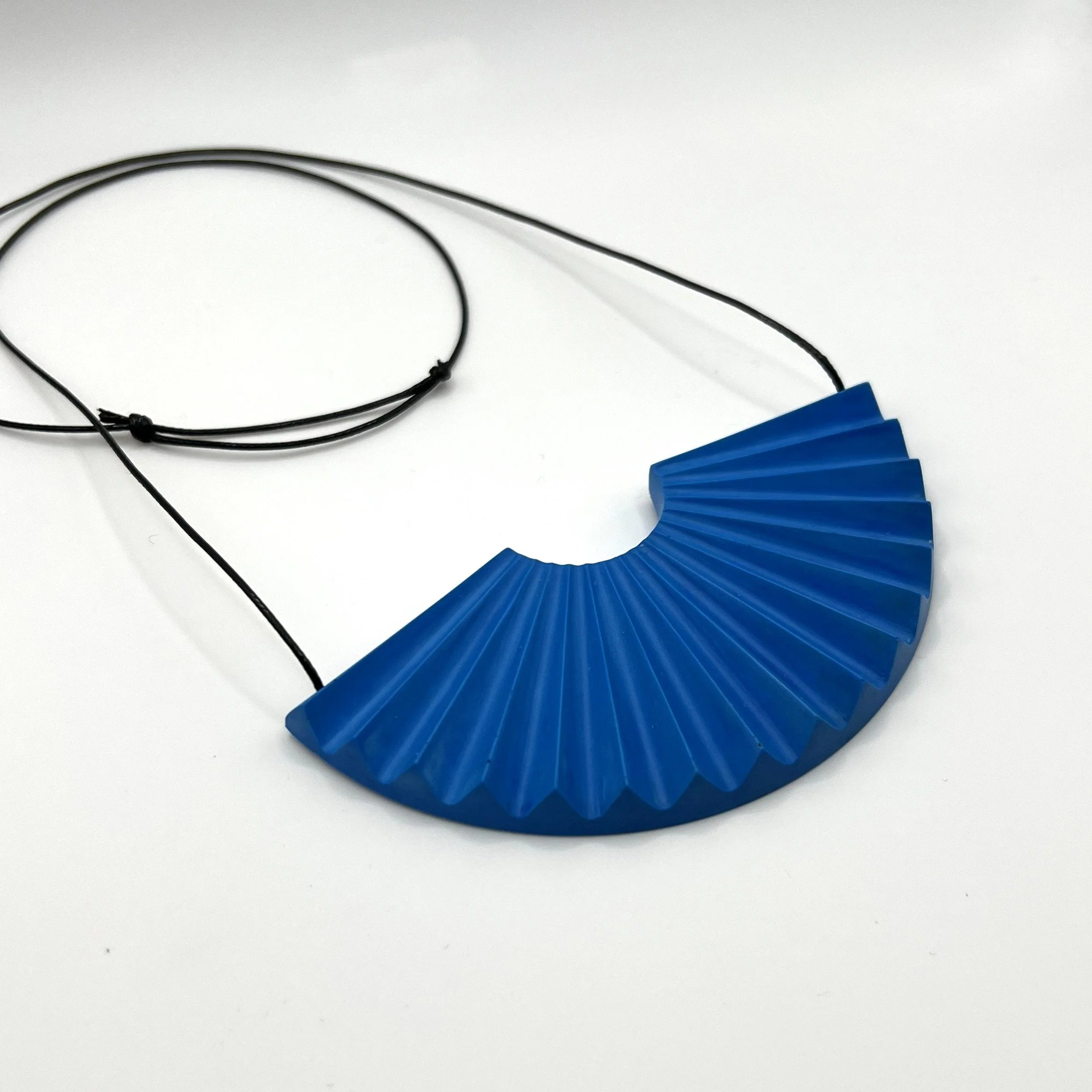blue jesmonite fan shaped statement necklace with adjustable black cord