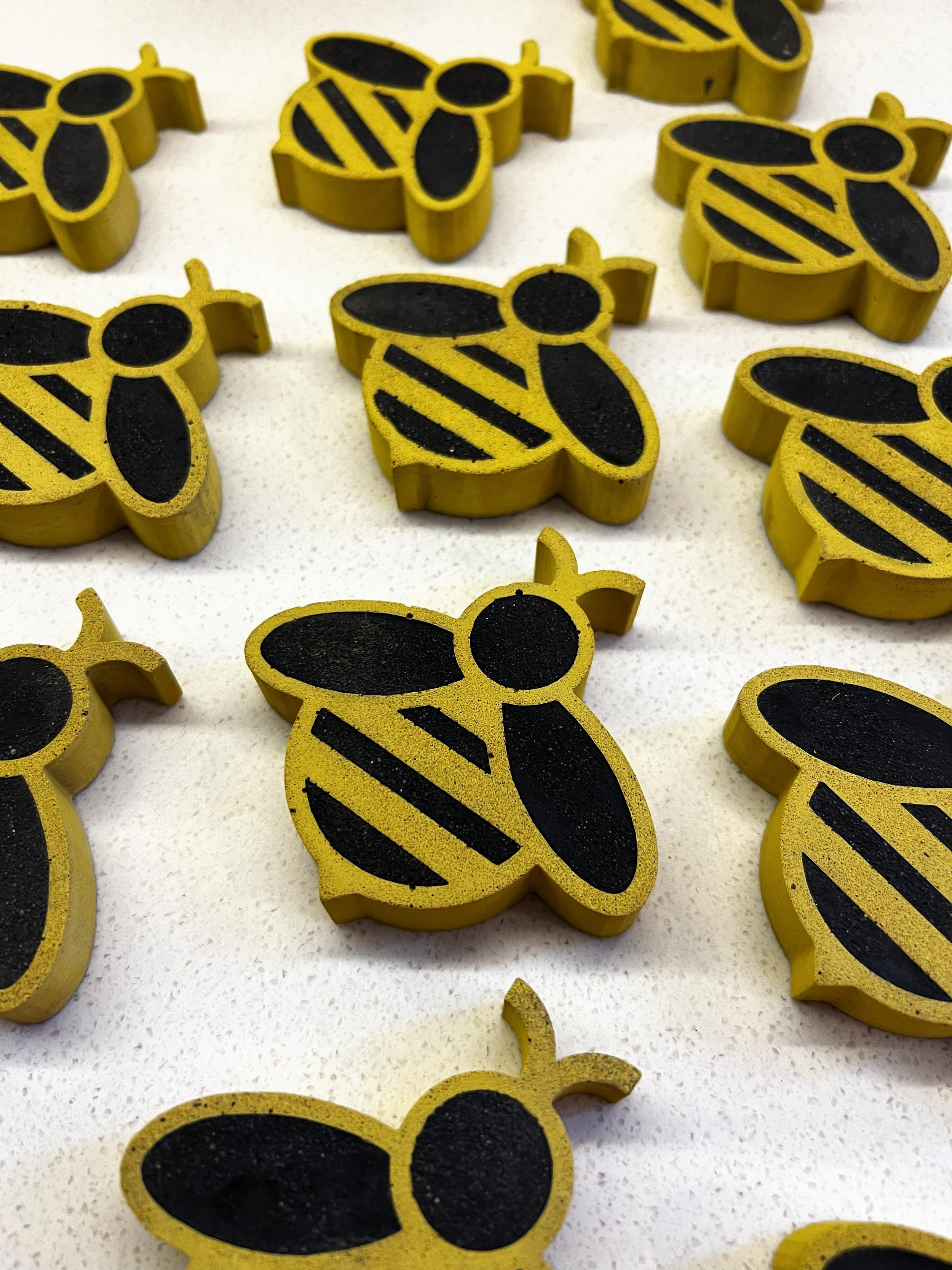 Yellow and black jesmonite bees created for friends of glasgow royal infirmary arts trail