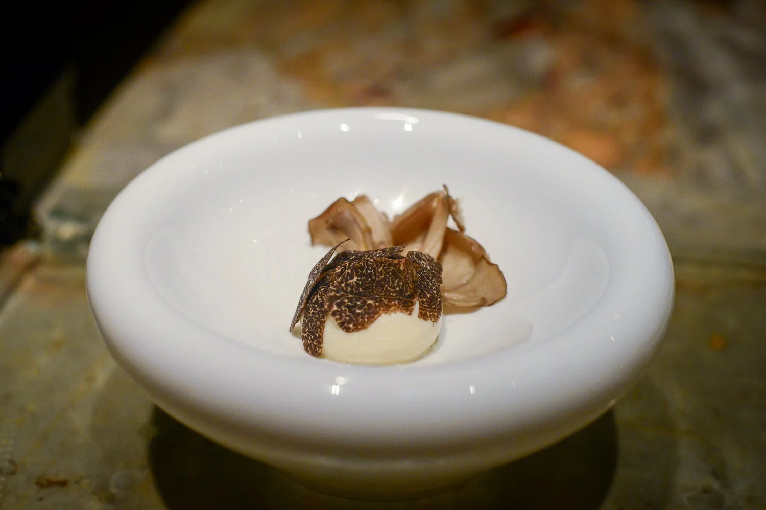  Onsen Tamago Maitake mushroom with truffles and a poached egg made as reverse spherification. The yolk (made of pumpkin) and the albumin (made of tofu) are double spherified in a mold 
