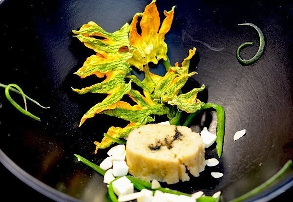  Warming   of pumpkin blossoms with turmeric, toasted almonds, and poblano chilli. 