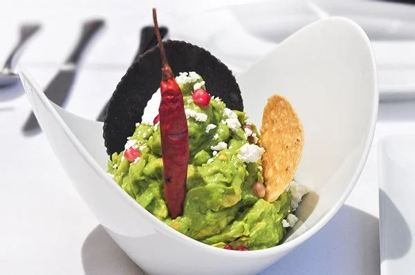  The  guacamole tricolor , topped with fresh cheese and pomegranate seeds, is familiar and newly alive. 