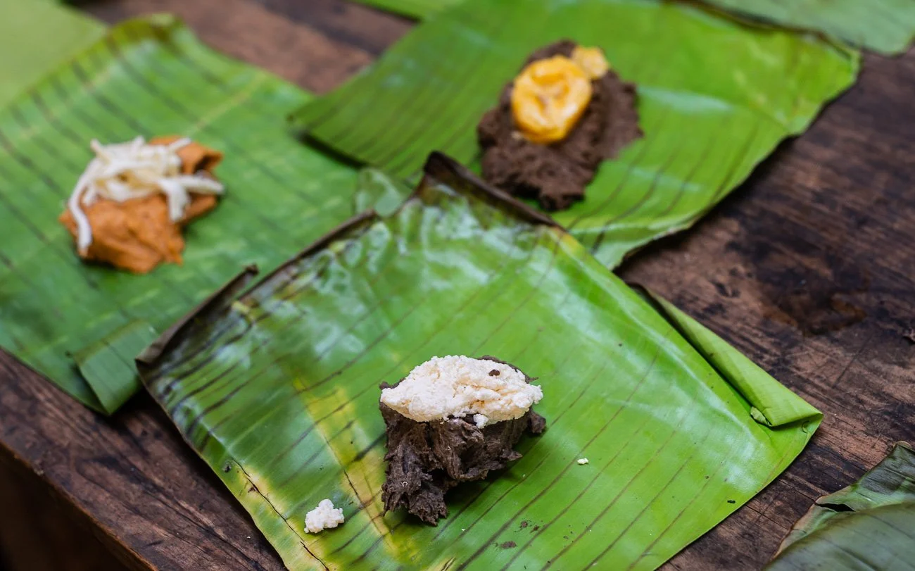  3. The masa is spooned into the wrapper.  4. The fillings are layered on top. 