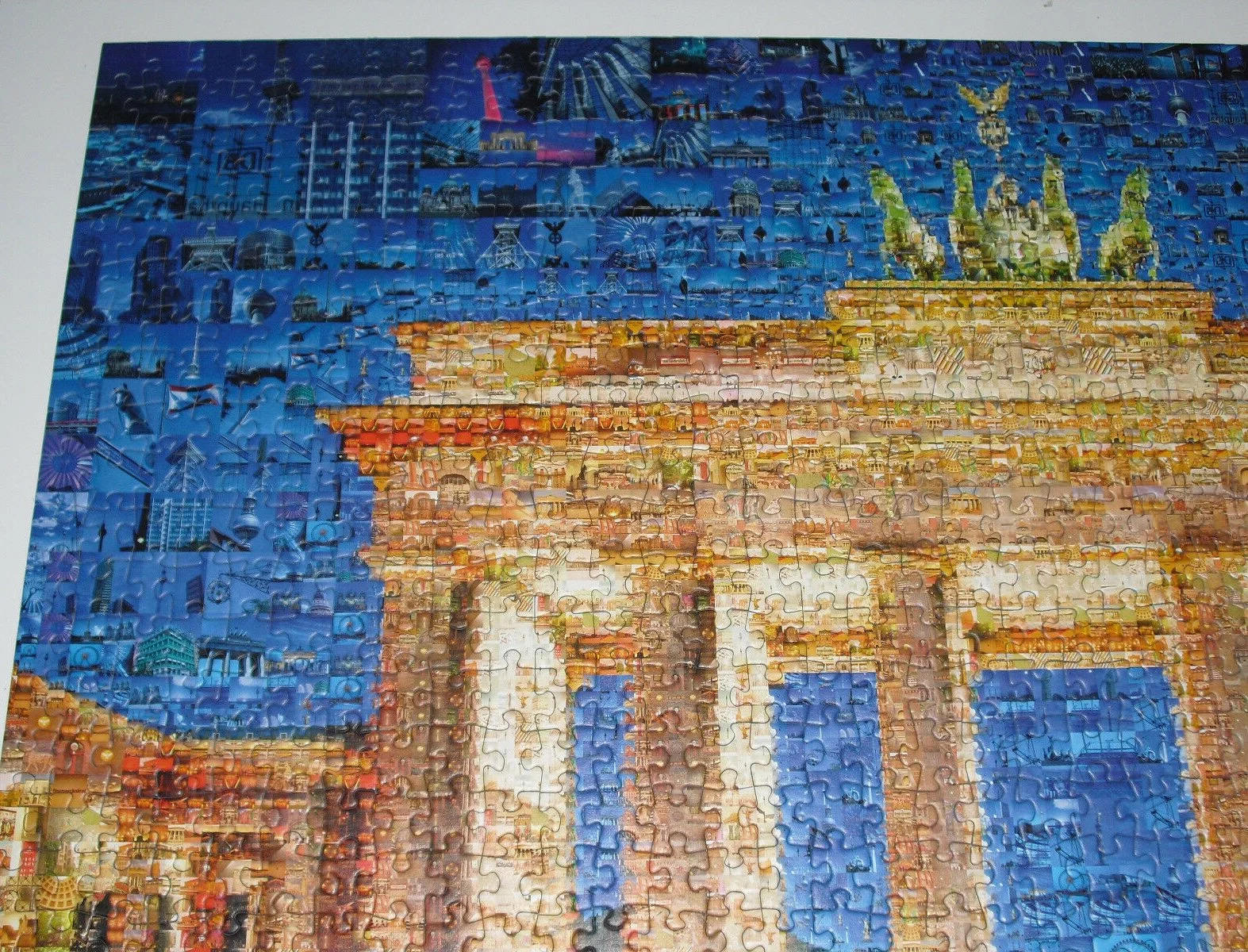 Assembled jigsaw puzzle of the Brandenburg Gate mosaic, built from many small photos of Berlin 