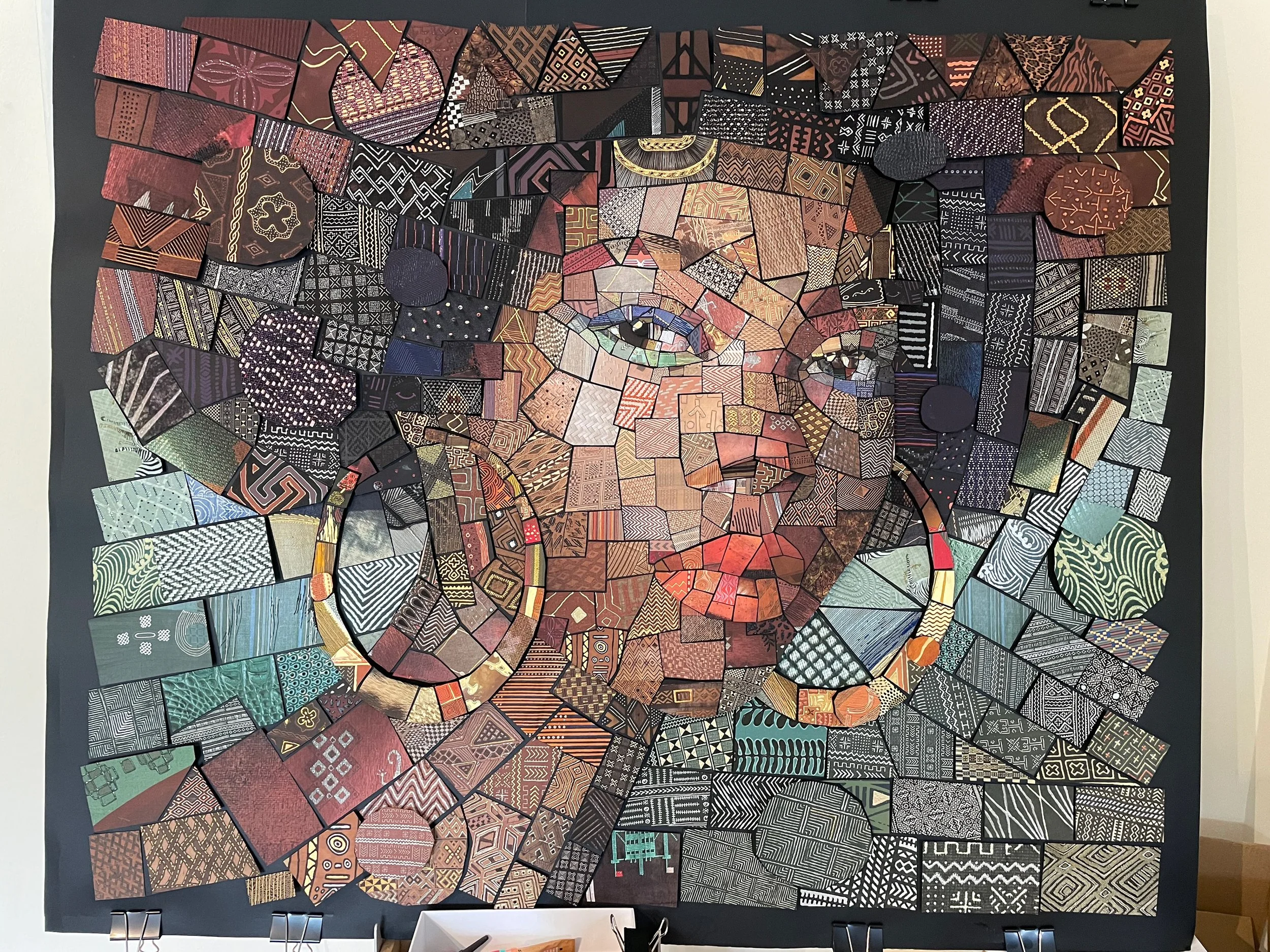  hand-cutting individual paper tiles for the analog version of The African Bricks 