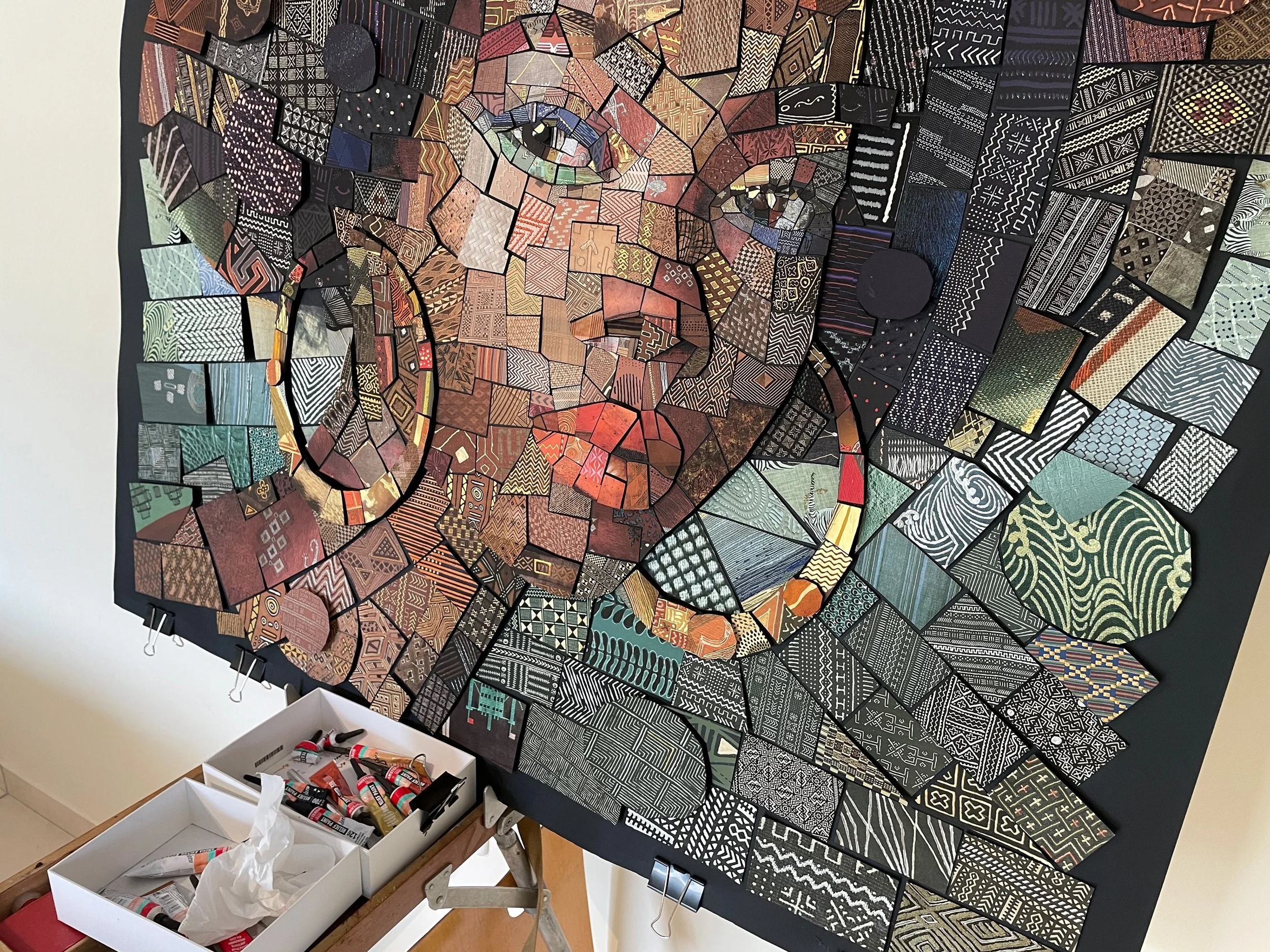  hand-cutting individual paper tiles for the analog version of The African Bricks Art 