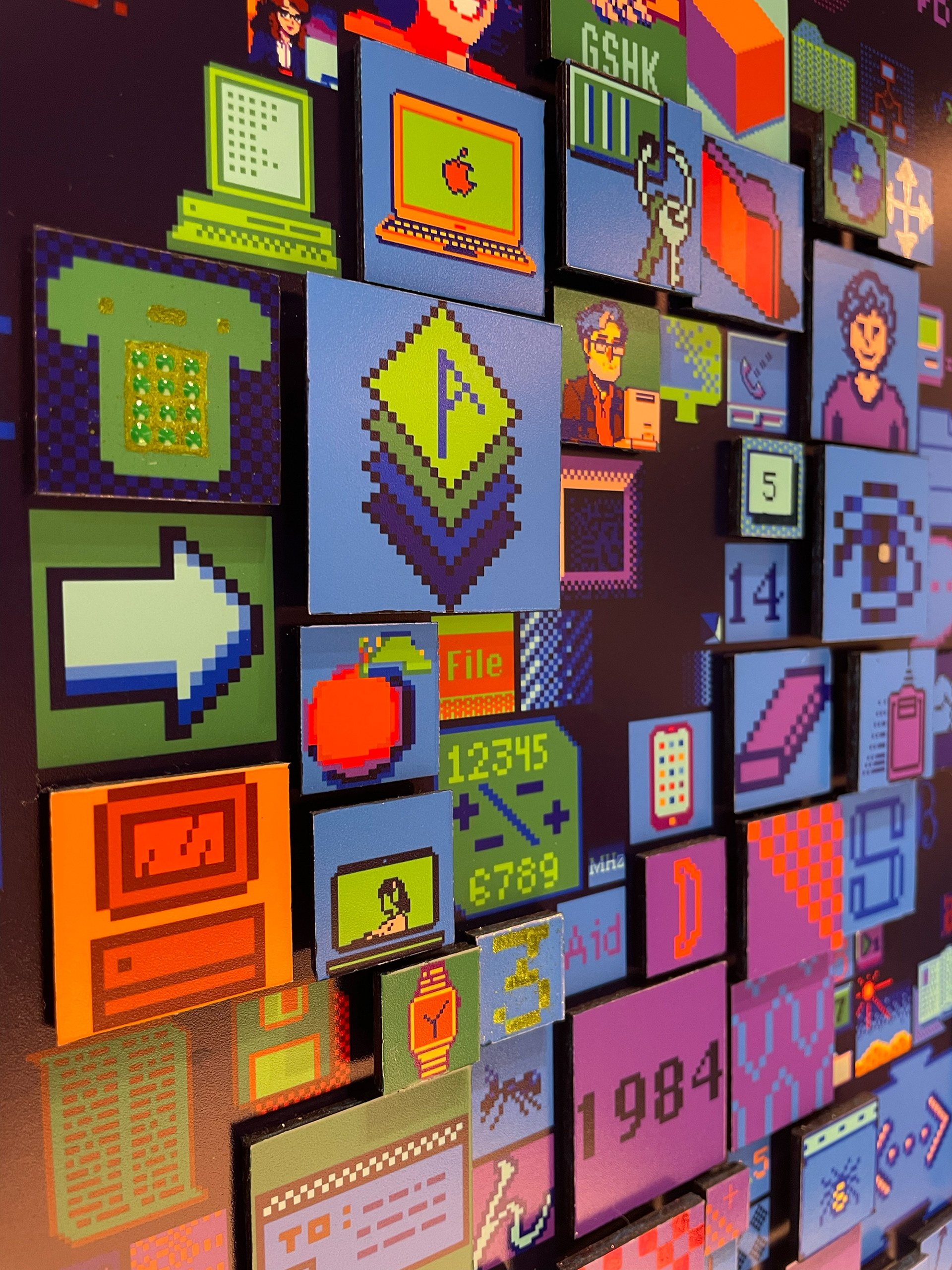  Detailed close-up of Charis Tsevis' digital mosaic &amp;quot;HELLO&amp;quot; artwork for Apple headquarters showing pixelated interface elements including Susan Kare's iconic designs, Macintosh interfaces, and modern digital symbols spanning four de