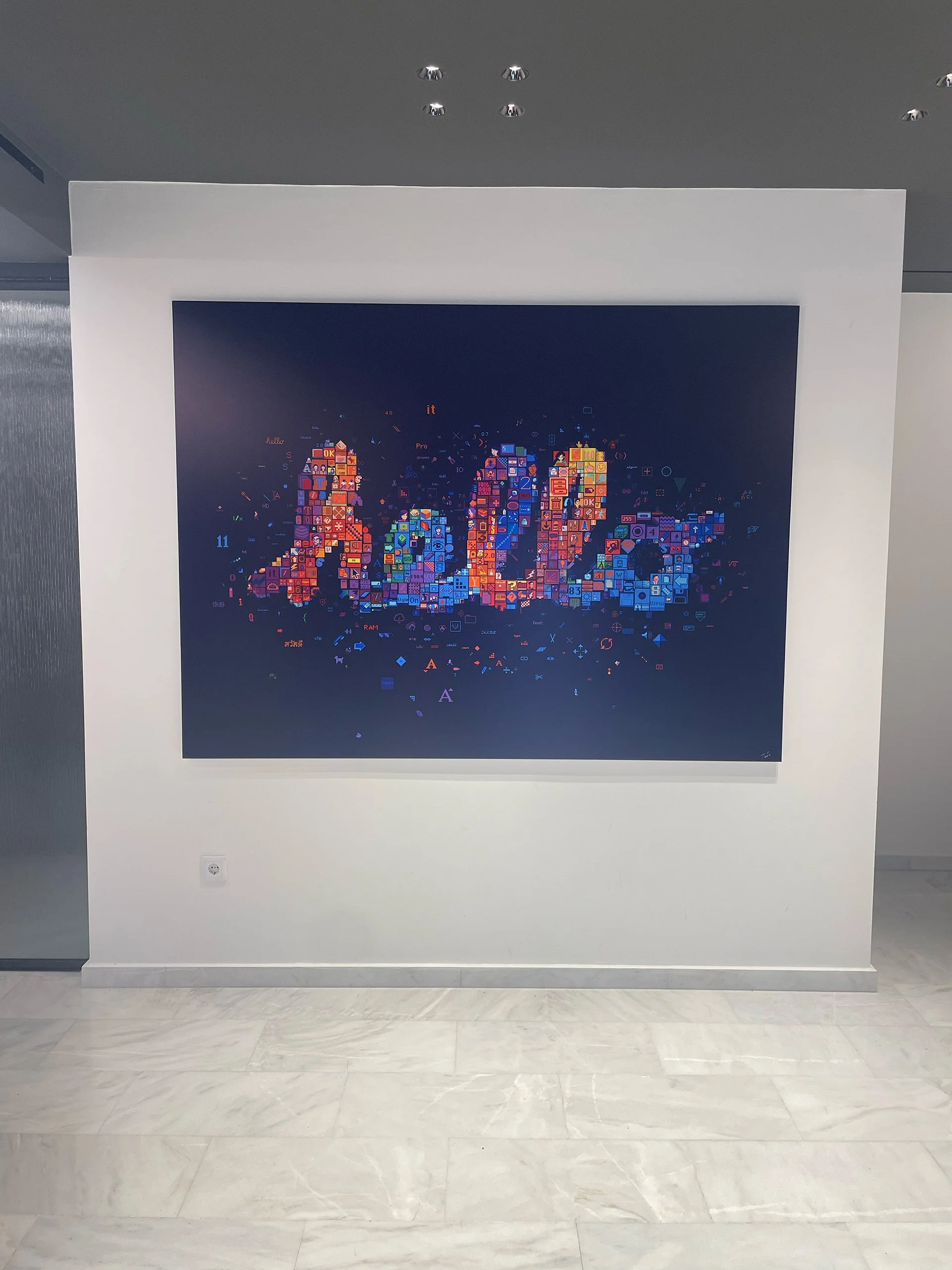  Large-format digital mosaic “HELLO” by Charis Tsevis, installed in Apple/iSquare headquarters; composed of 40+ years of Apple interface icons including Susan Kare designs and pixel art elements 